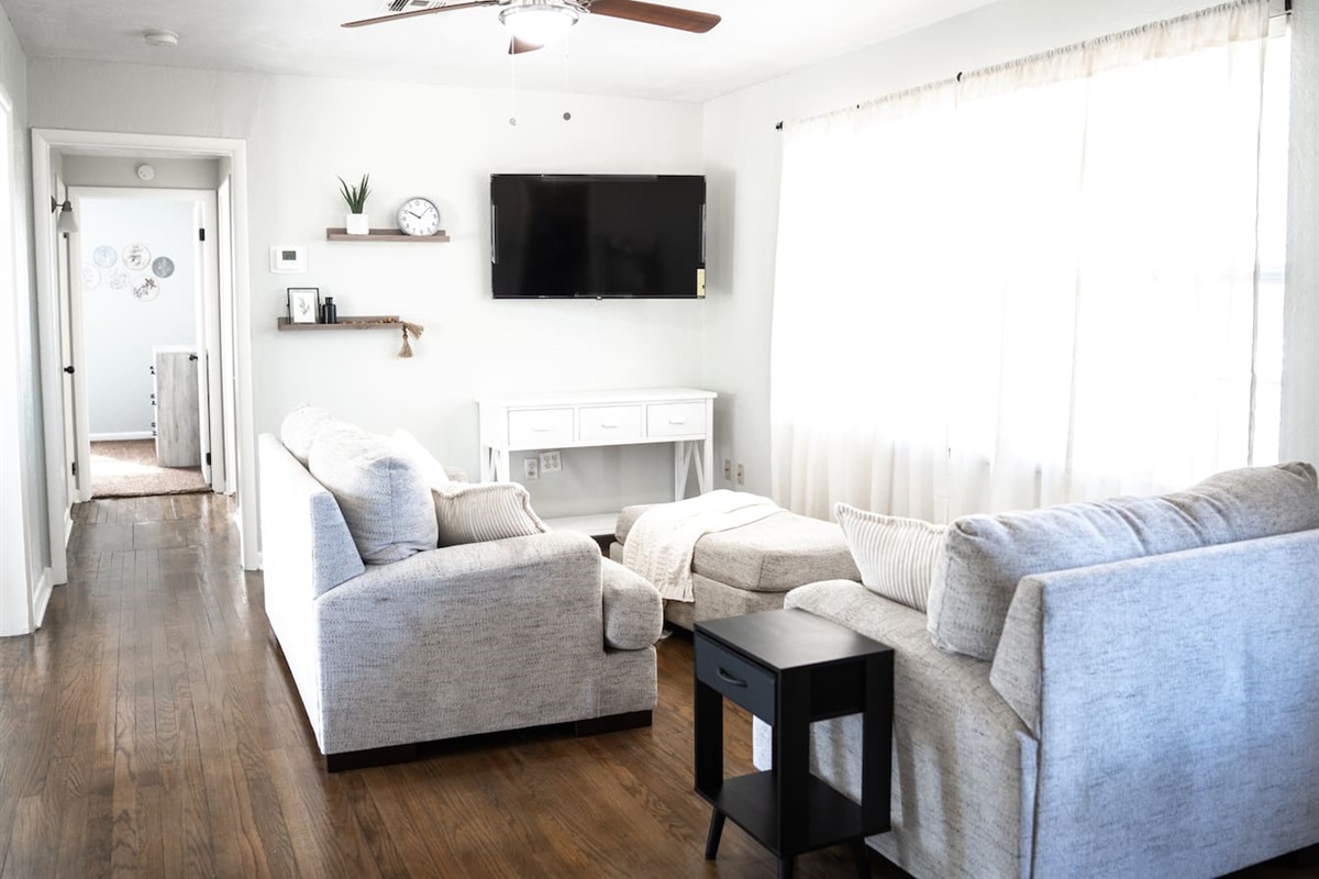 Inviting living room with smart TV and plenty of comfort.