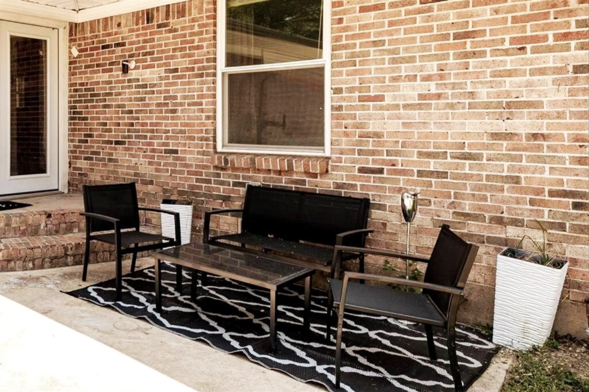 Outdoor seating area with glass coffee table and ashtray