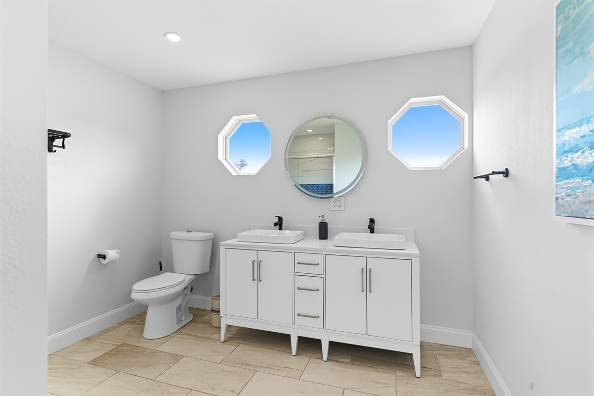 Upstairs master en suite offers dual vanities.