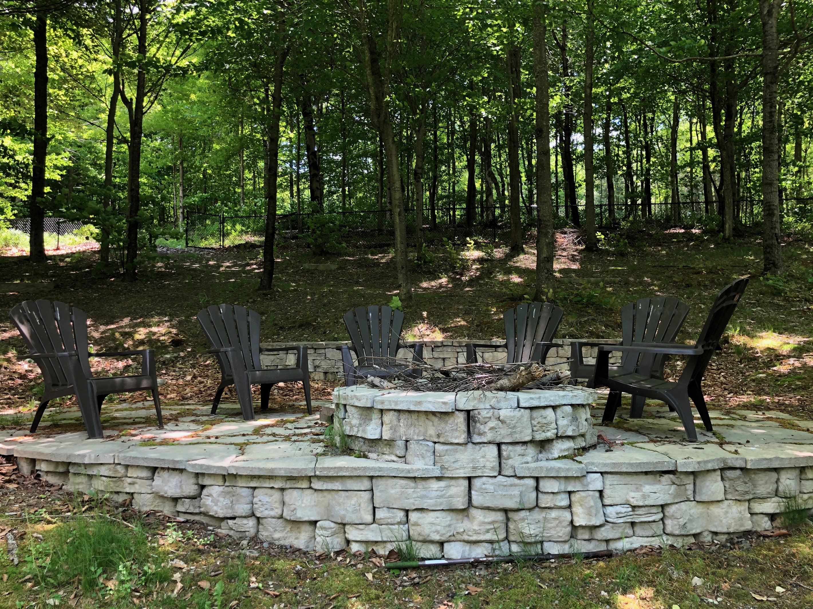 A built in fire pit with stone patio surround is sure to be a crowd pleaser.