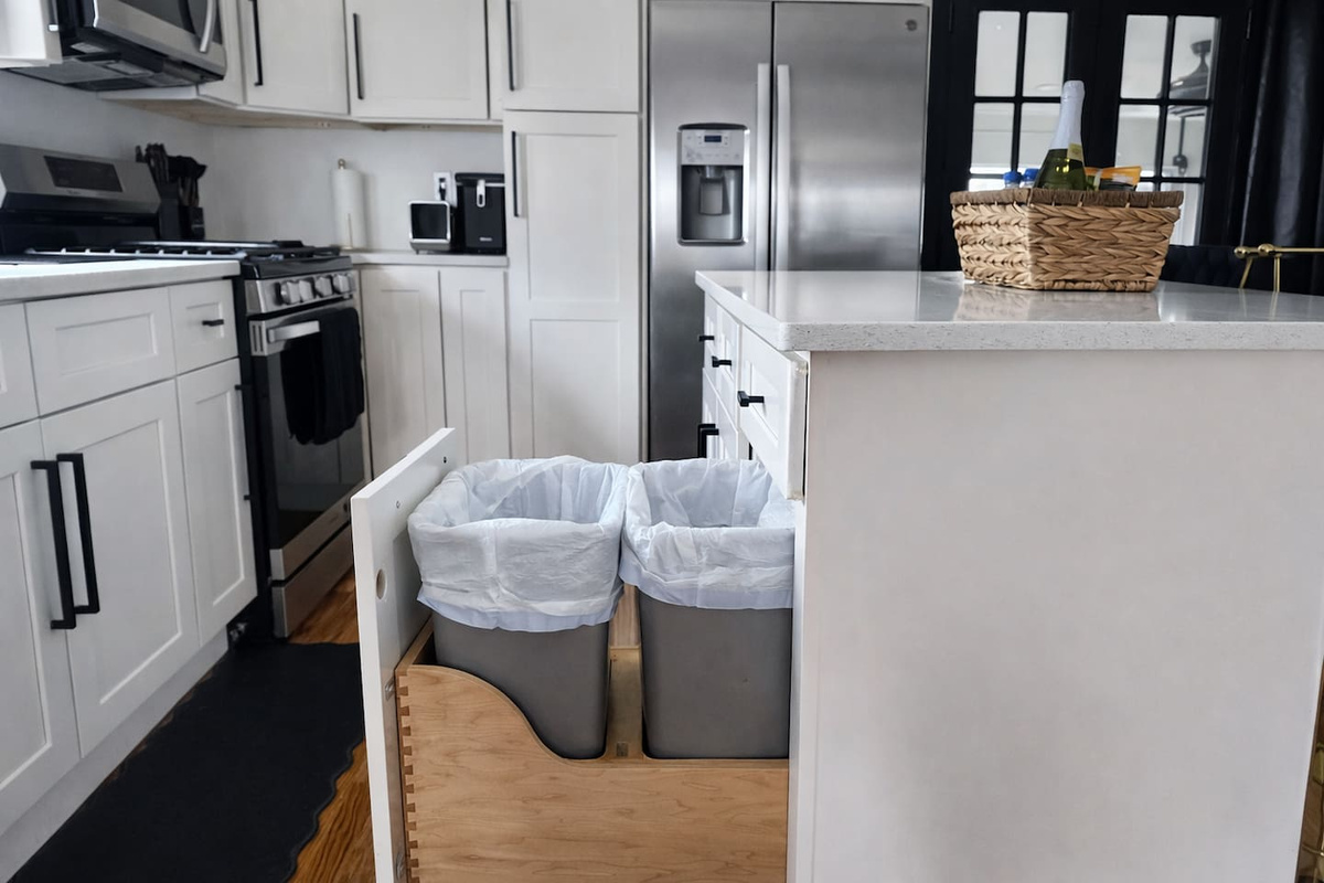 The trash cans are hidden under this cabinet so that your space always feels clean. 