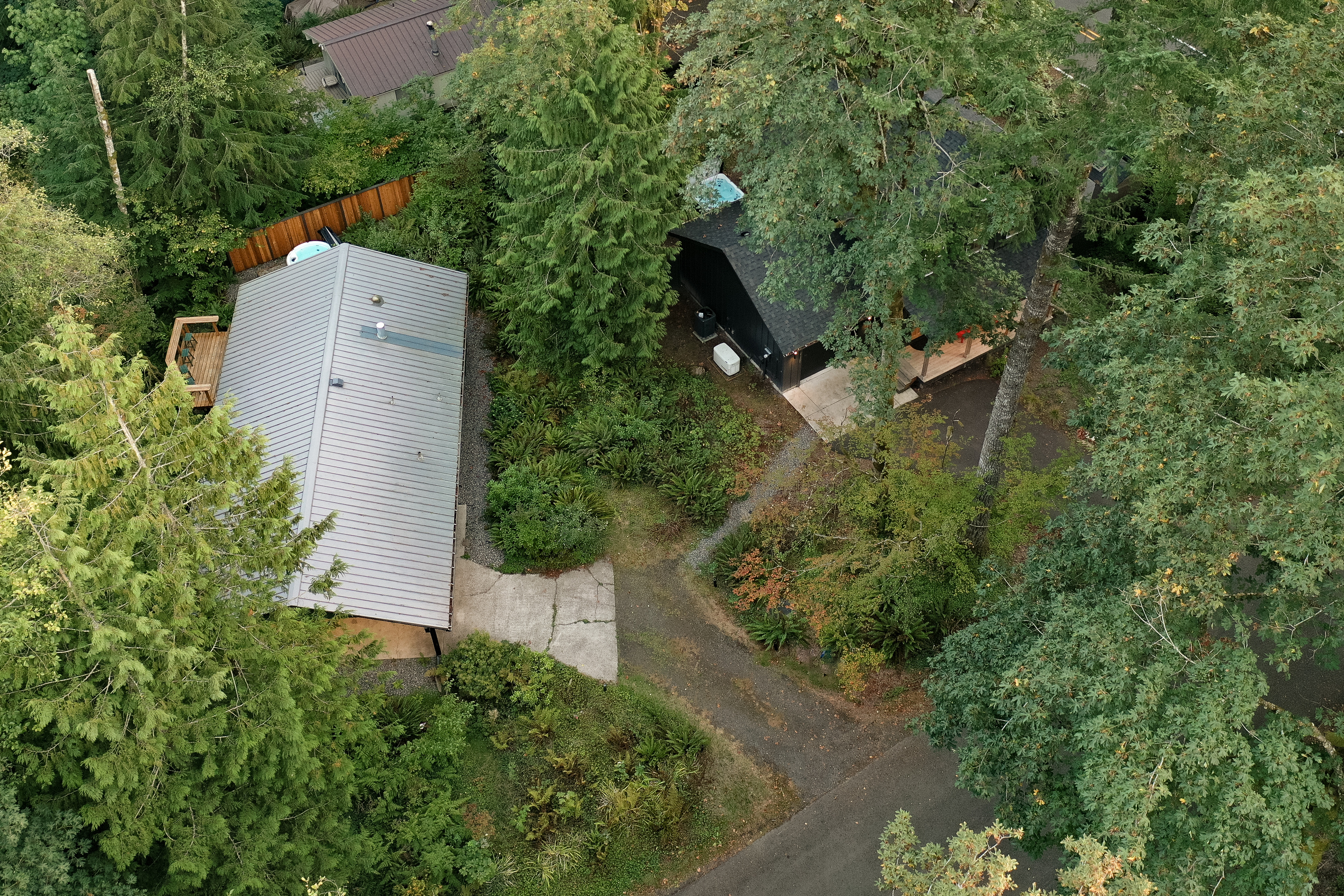 Side by side in the trees, cabins connected by a gravel path — ideal for two families traveling together.