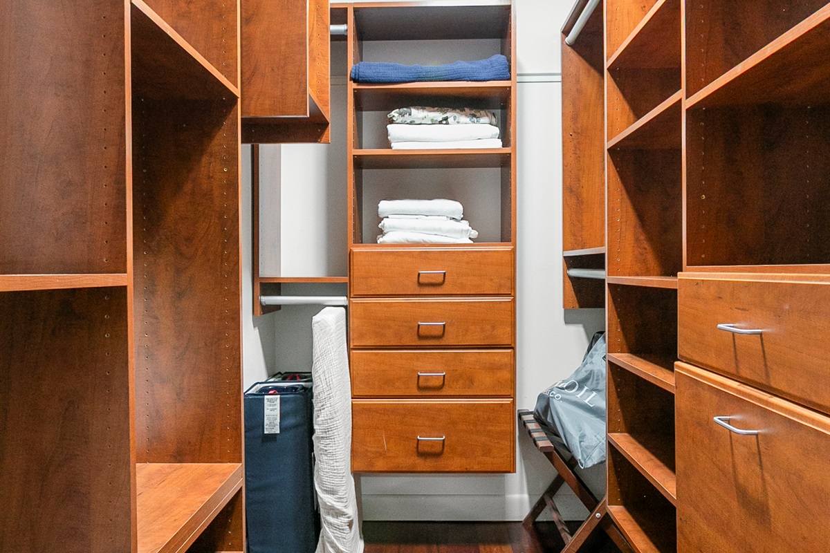 Walk in closet with ample storage, crib, air bed and extra linens.