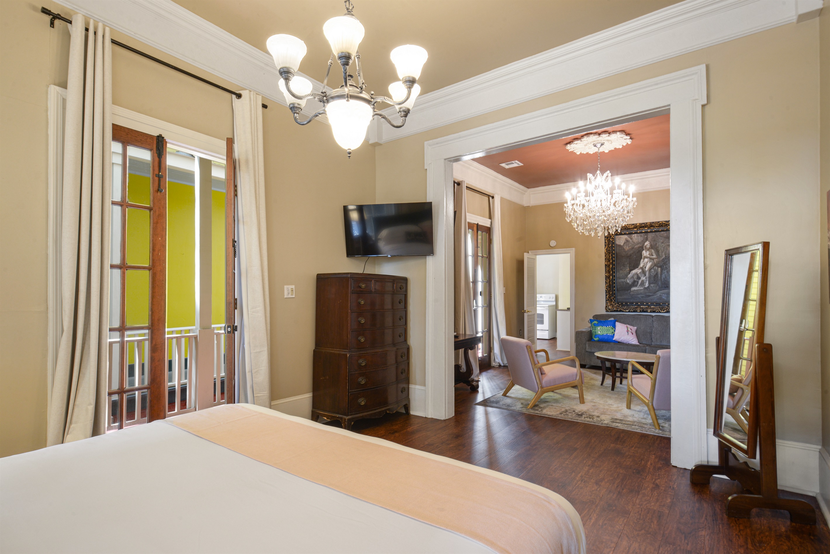 Grand king bedroom with 11-foot ceilings, a chandelier, and a private porch