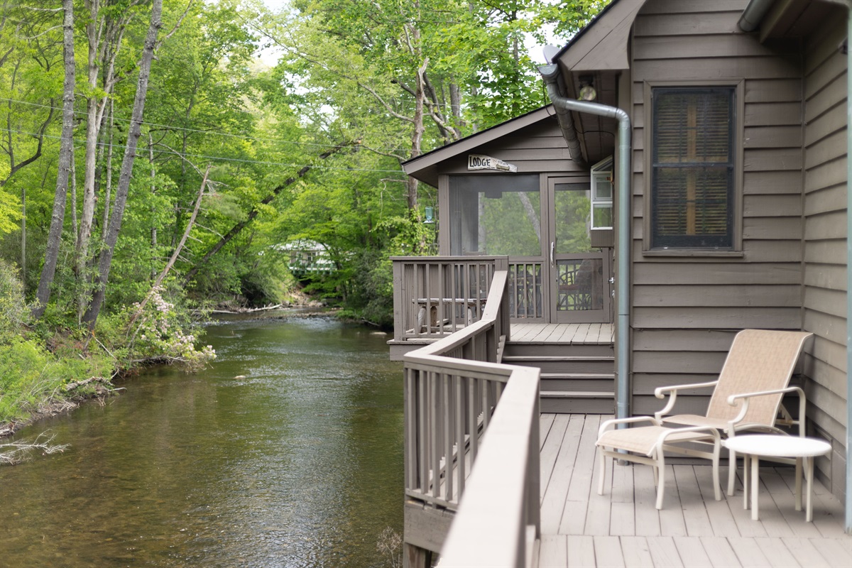 The spacious back deck overlooks Snowbird Creek and is designed for relaxing outdoor living.