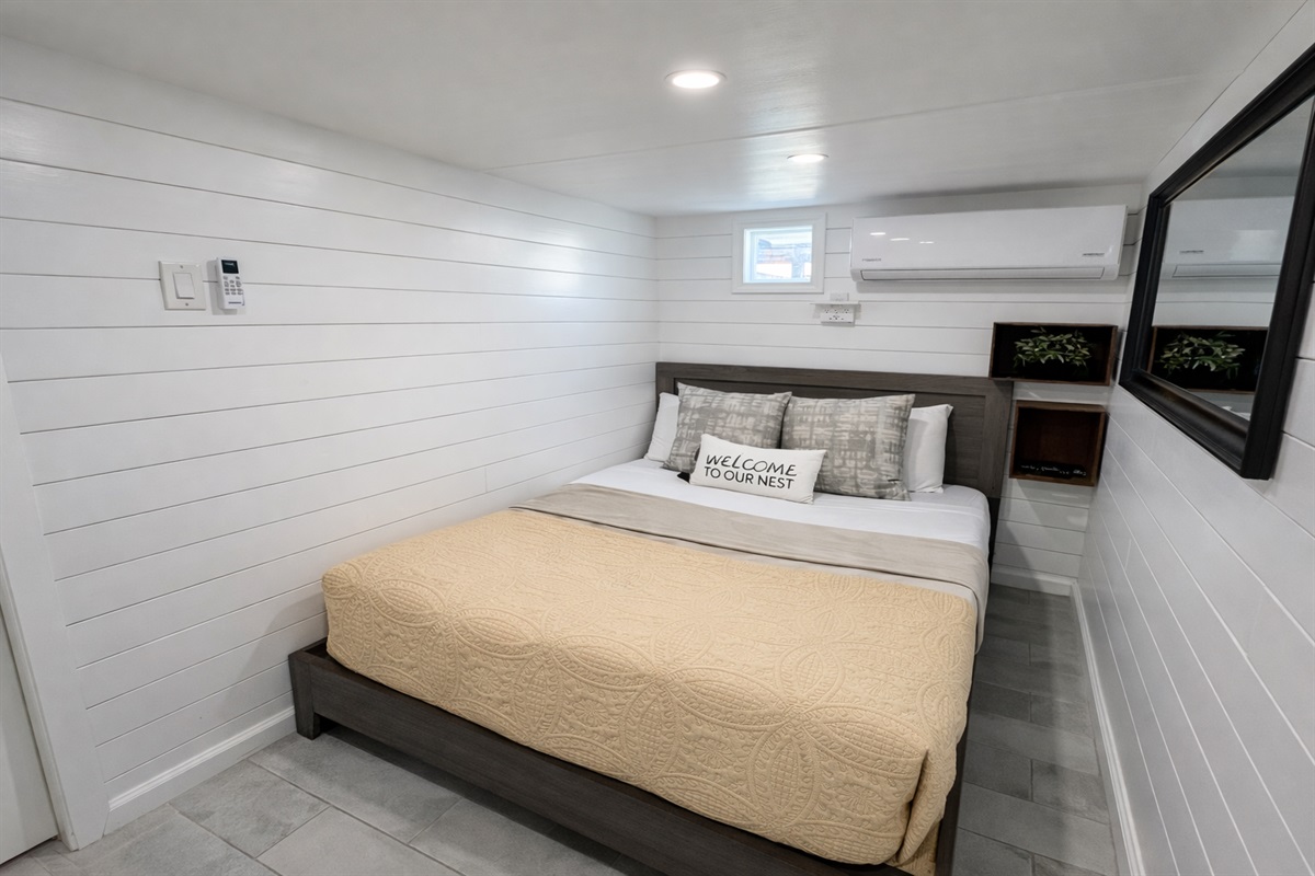 Downstairs bedroom with full size bed and smart tv