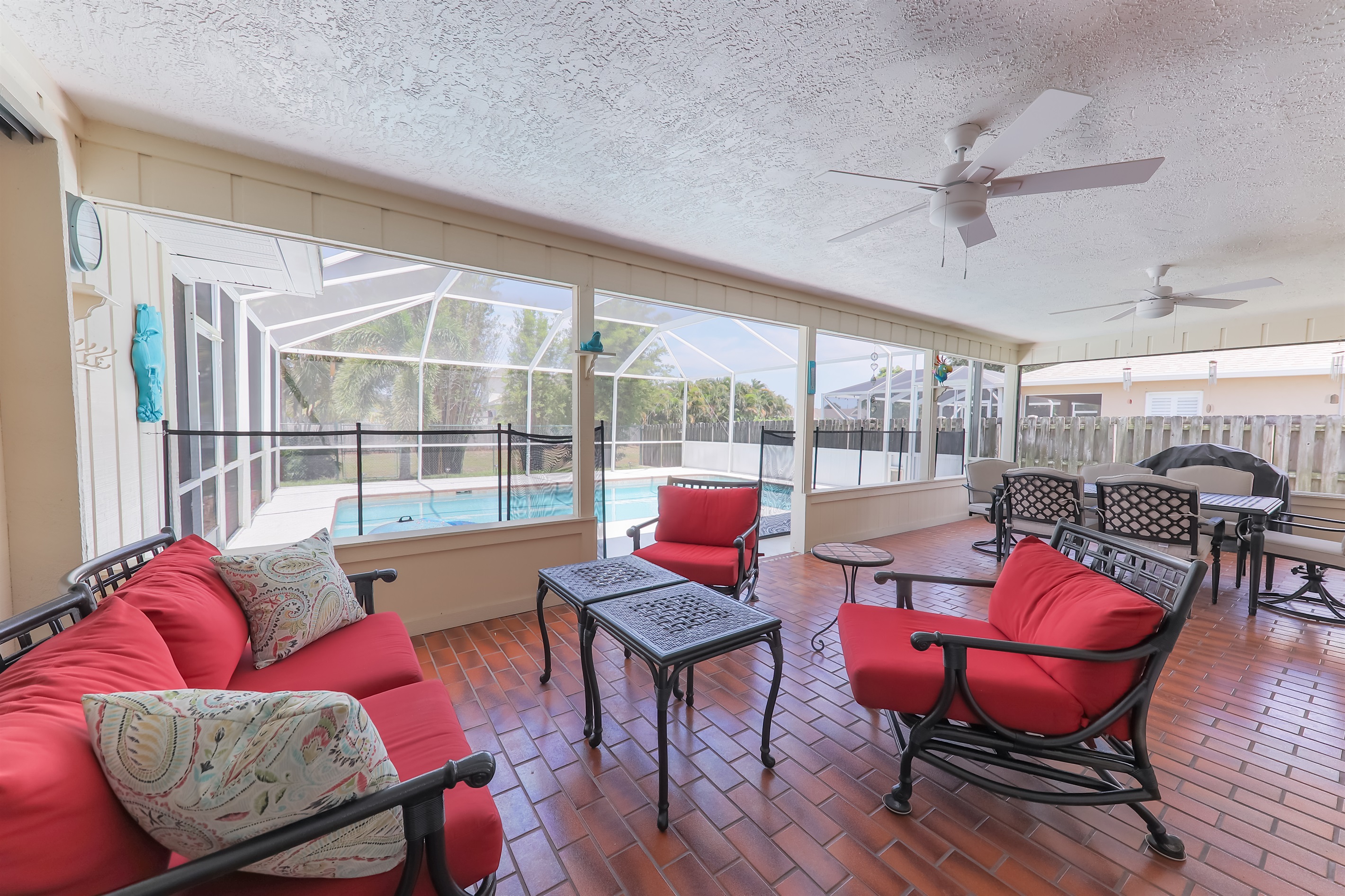 Lanai with relaxed seating, dining and views over the heated pool.