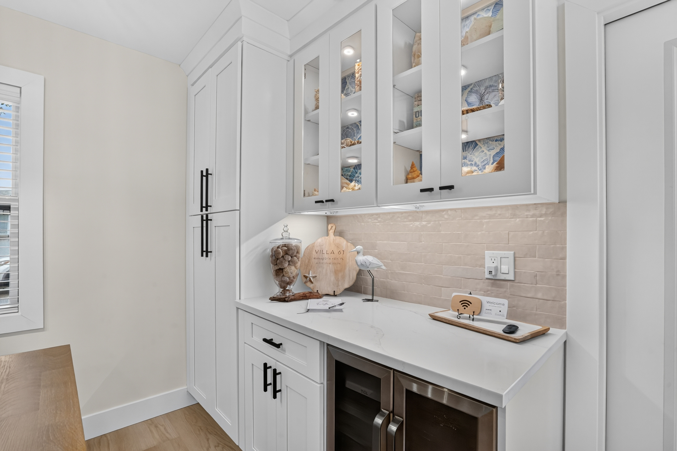 Built-in cabinetry provides additional serving space and storage beside the dining table.

