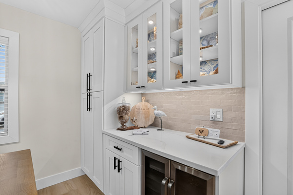 Built-in cabinetry provides additional serving space and storage beside the dining table.
