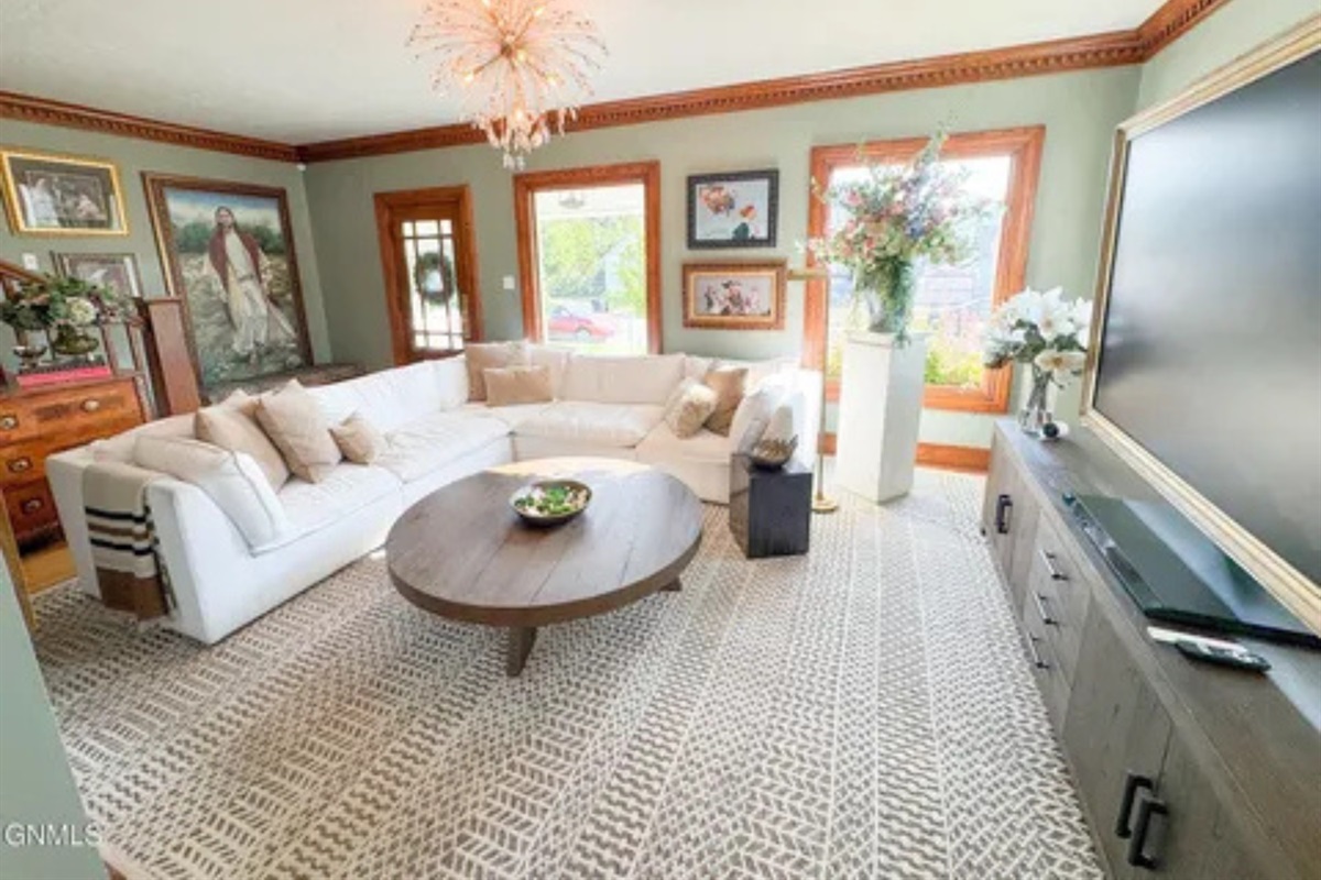 This spacious living room gives you a comfortable spot to stretch out, chat, or watch TV together.