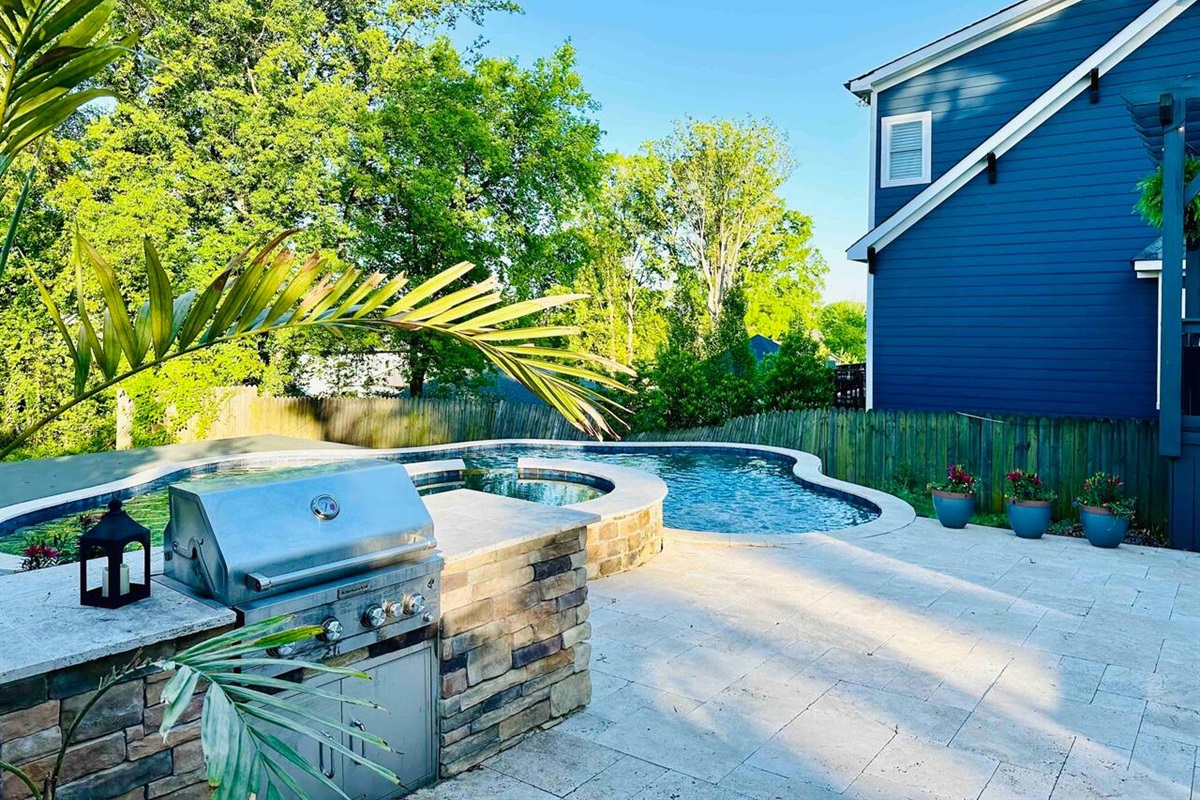 Built in grill for outdoor kitchen experience overlooking the pool.