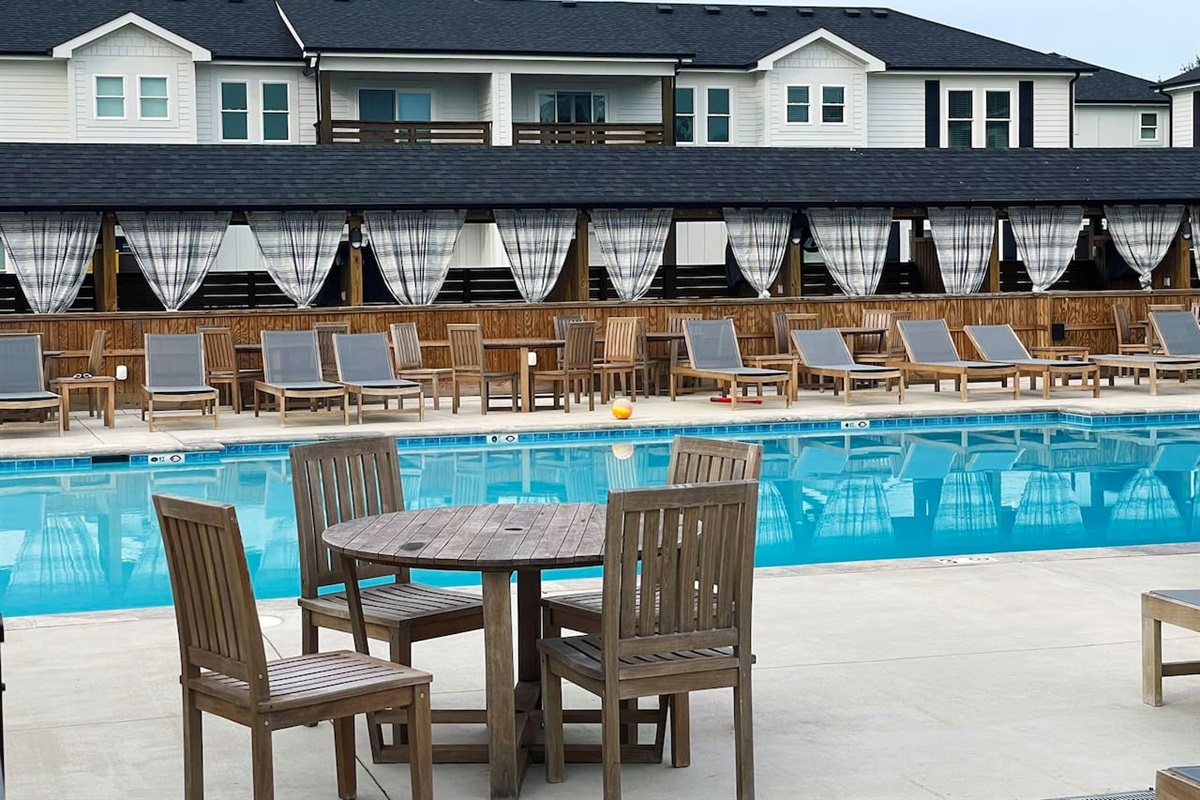 Take in the resort amenities with this expansive heated pool, surrounding sun loungers, and relaxing shared outdoor spaces.