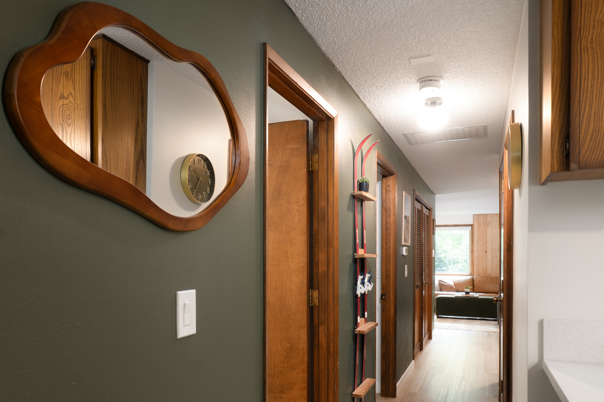 Retro details throughout — like this hallway mirror and vintage ski display — give the cabin its one-of-a-kind personality.