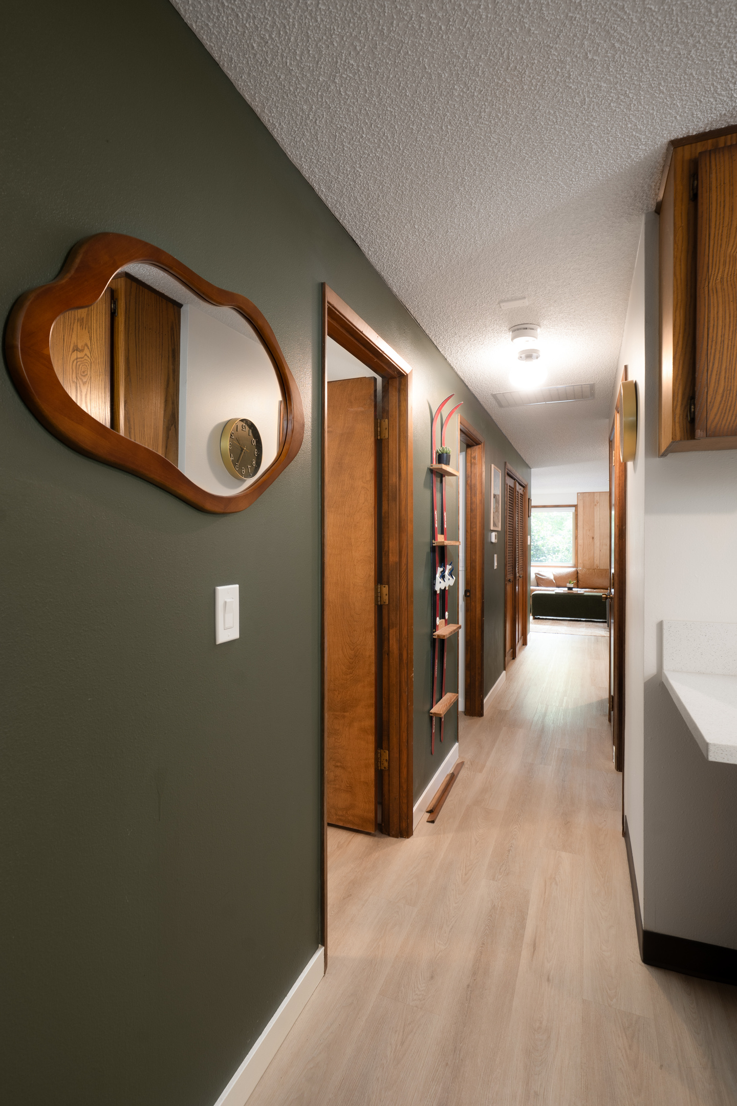 Retro details throughout — like this hallway mirror and vintage ski display — give the cabin its one-of-a-kind personality.