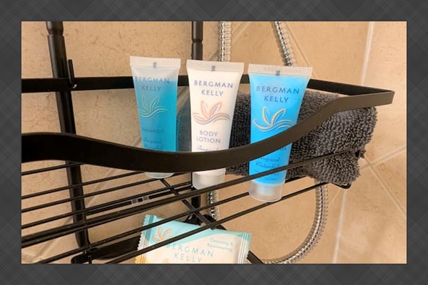 Bathroom features complimentary shampoo, conditioner, lotion, and bar soap in the shower. 