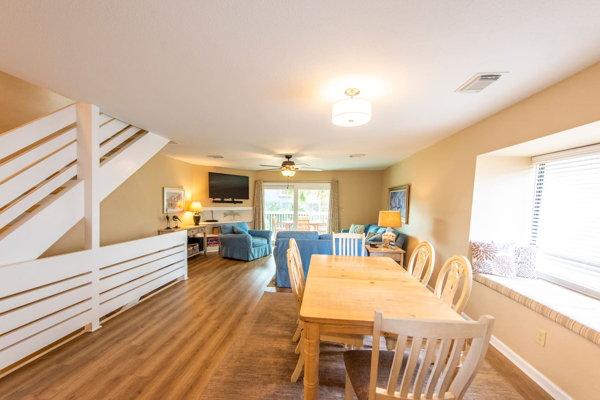 Gather the whole group at the dining table while Gulf light pours through the bay window &mdash; this is the room everyone ends up in, morning and evening both.