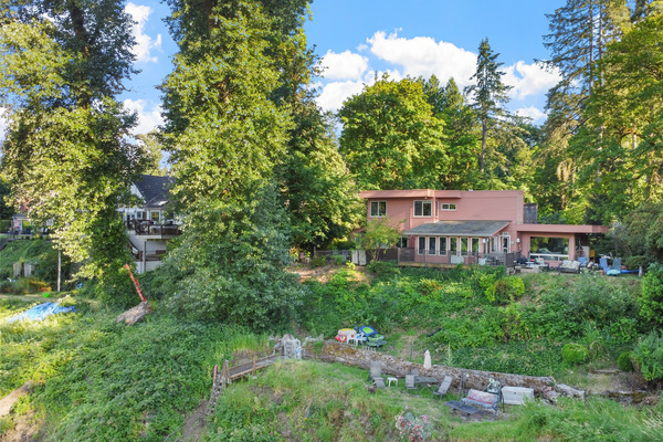 The property from above — you'll stay in the private cottage (own entrance & parking); your hosts live in the main home.