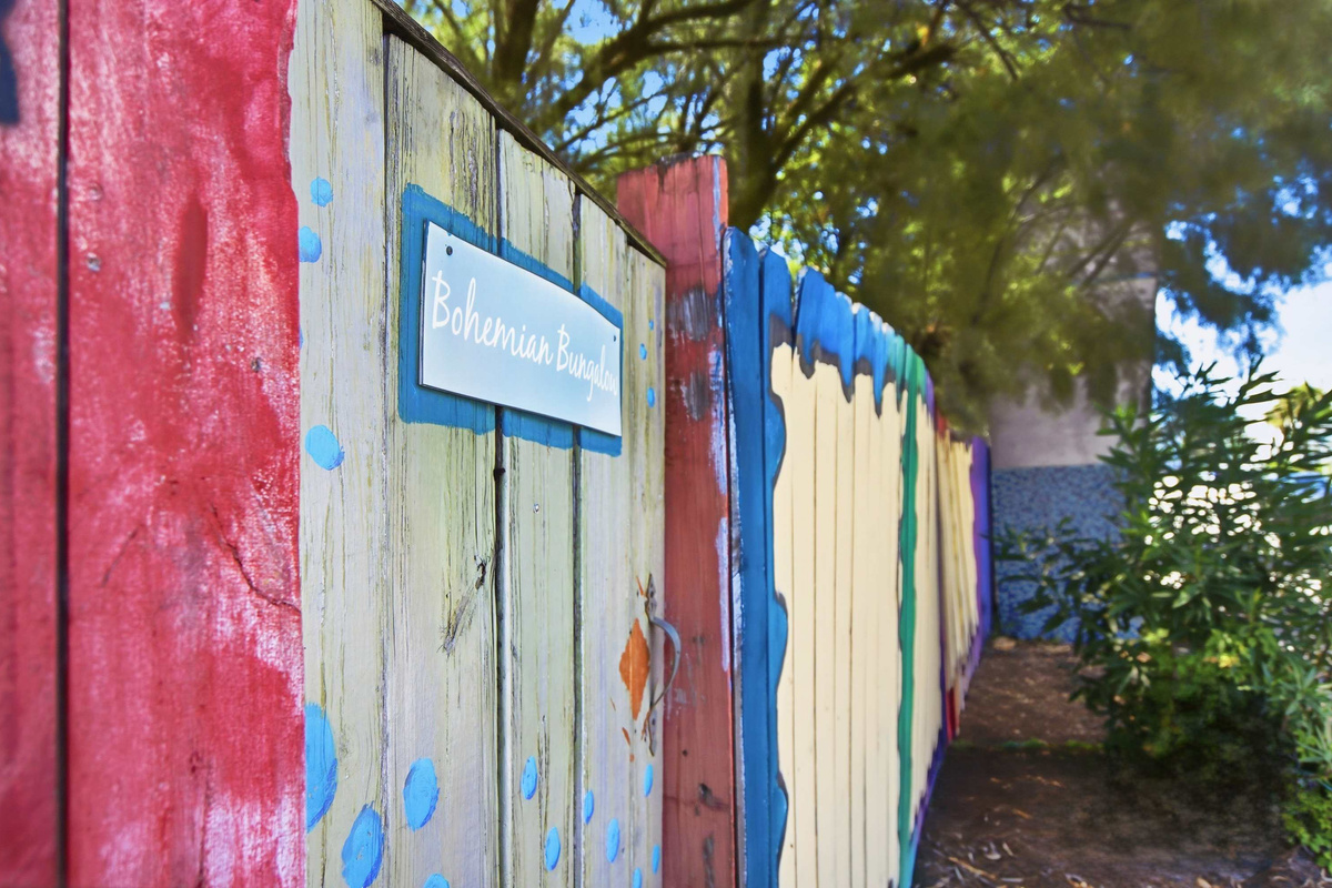 More of the painted fence, this stretch done in reds and driftwood blues. Small details like this are exactly why people keep coming back to this corner of Vilano rather than the big resorts further down the coast.
