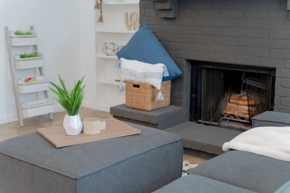 Open living room with fireplace and stylish decor.