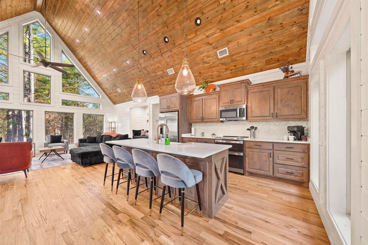 Open kitchen with ample counter space and bar seating.