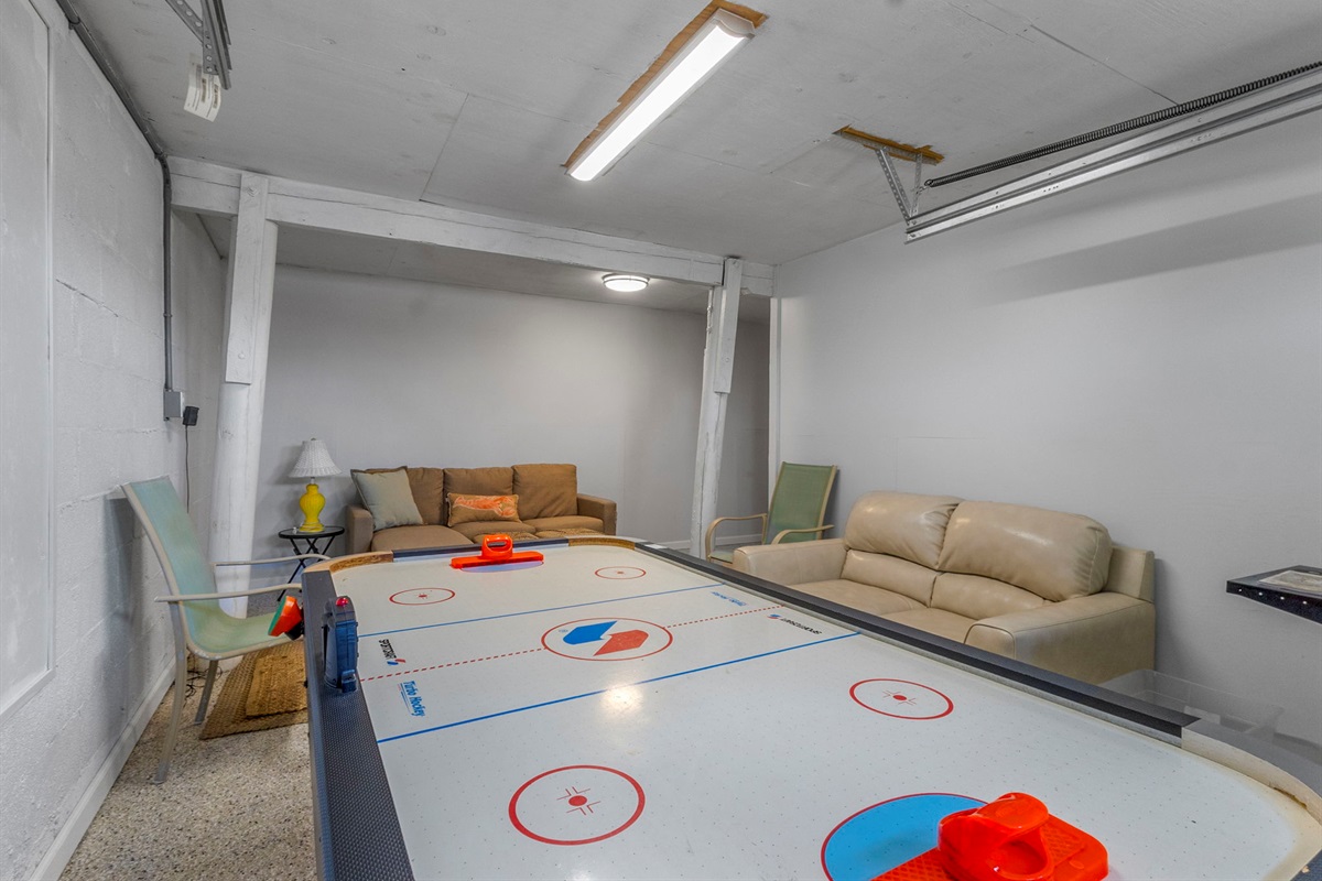 The Game Room has a small sectional and a loveseat as well as an air hockey table.