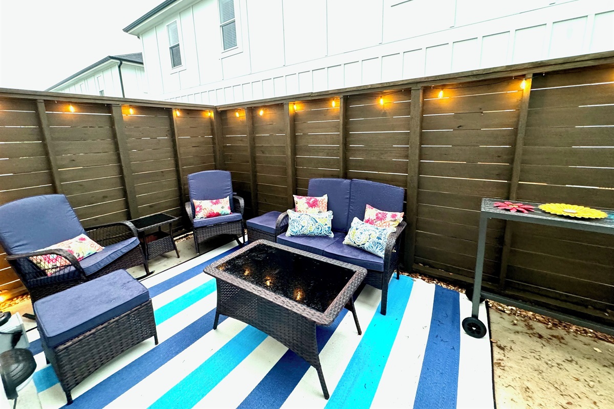 Back patioEnclosed at other end with baby gatesLightedGrillOutdoor Shower