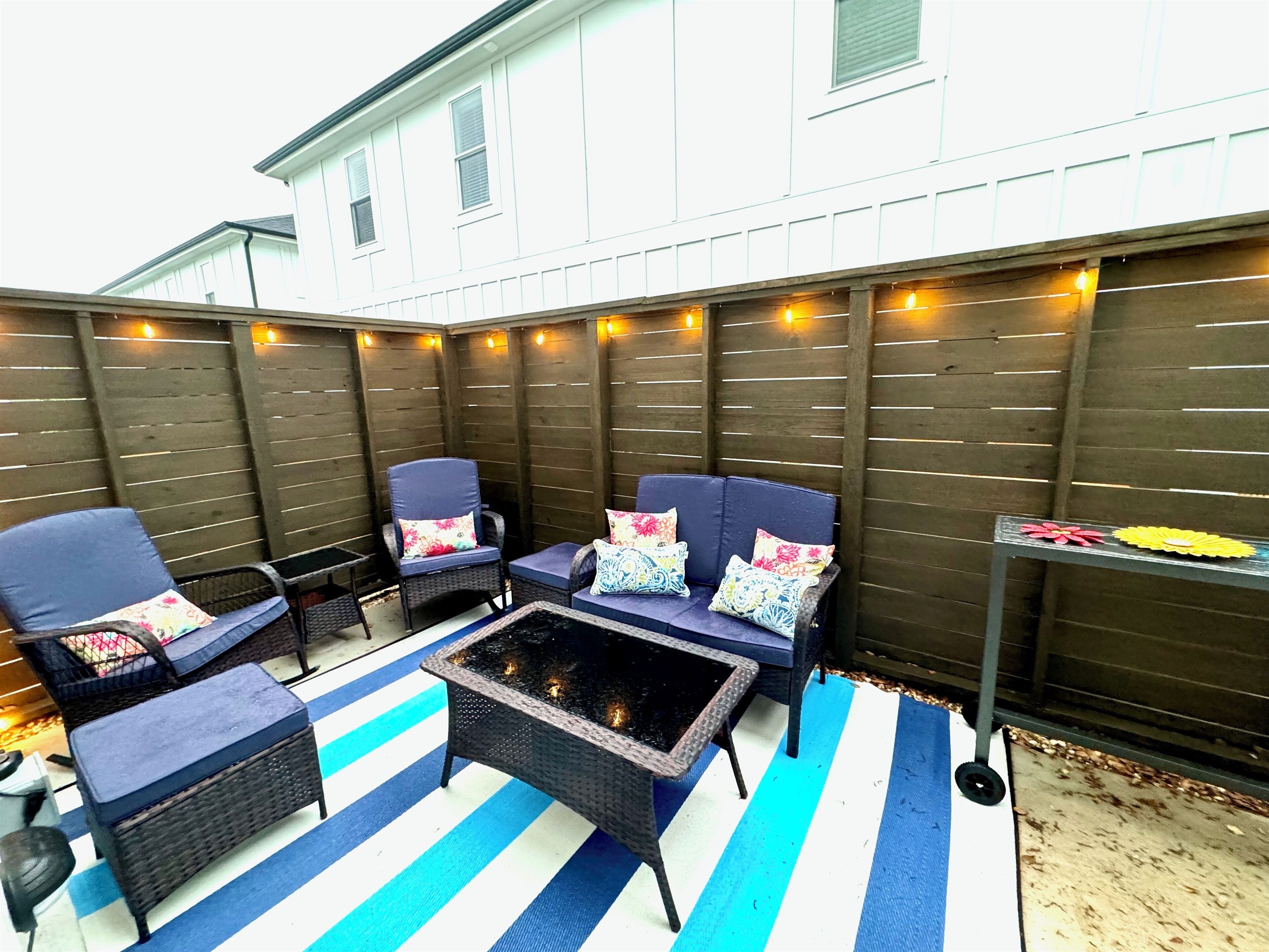 Back patioEnclosed at other end with baby gatesLightedGrillOutdoor Shower