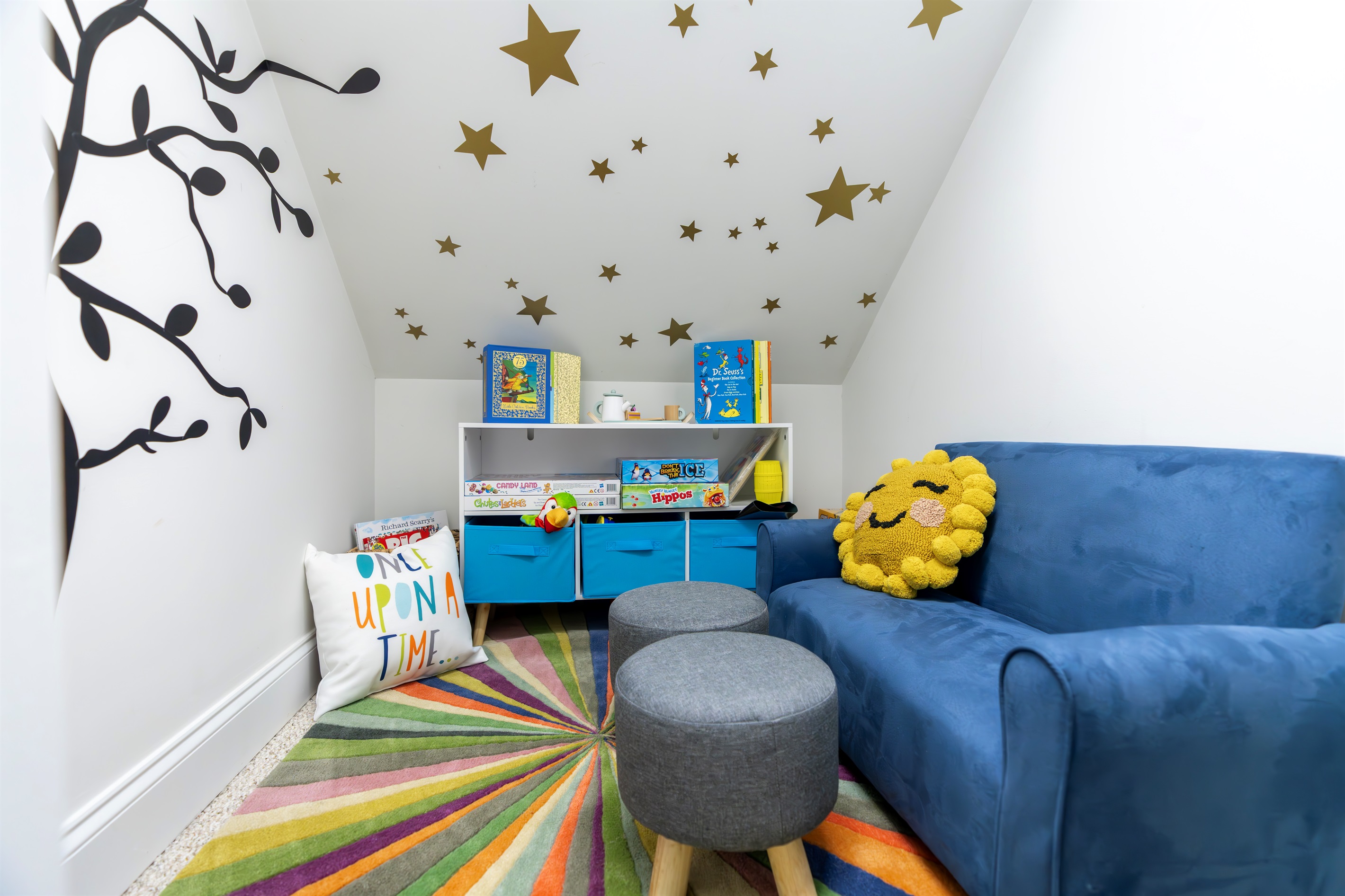 A magical reading nook tucked beneath the eaves—stocked with books, games,toys, and imagination. Kid size furniture. Curtain closes for a grown-up reset