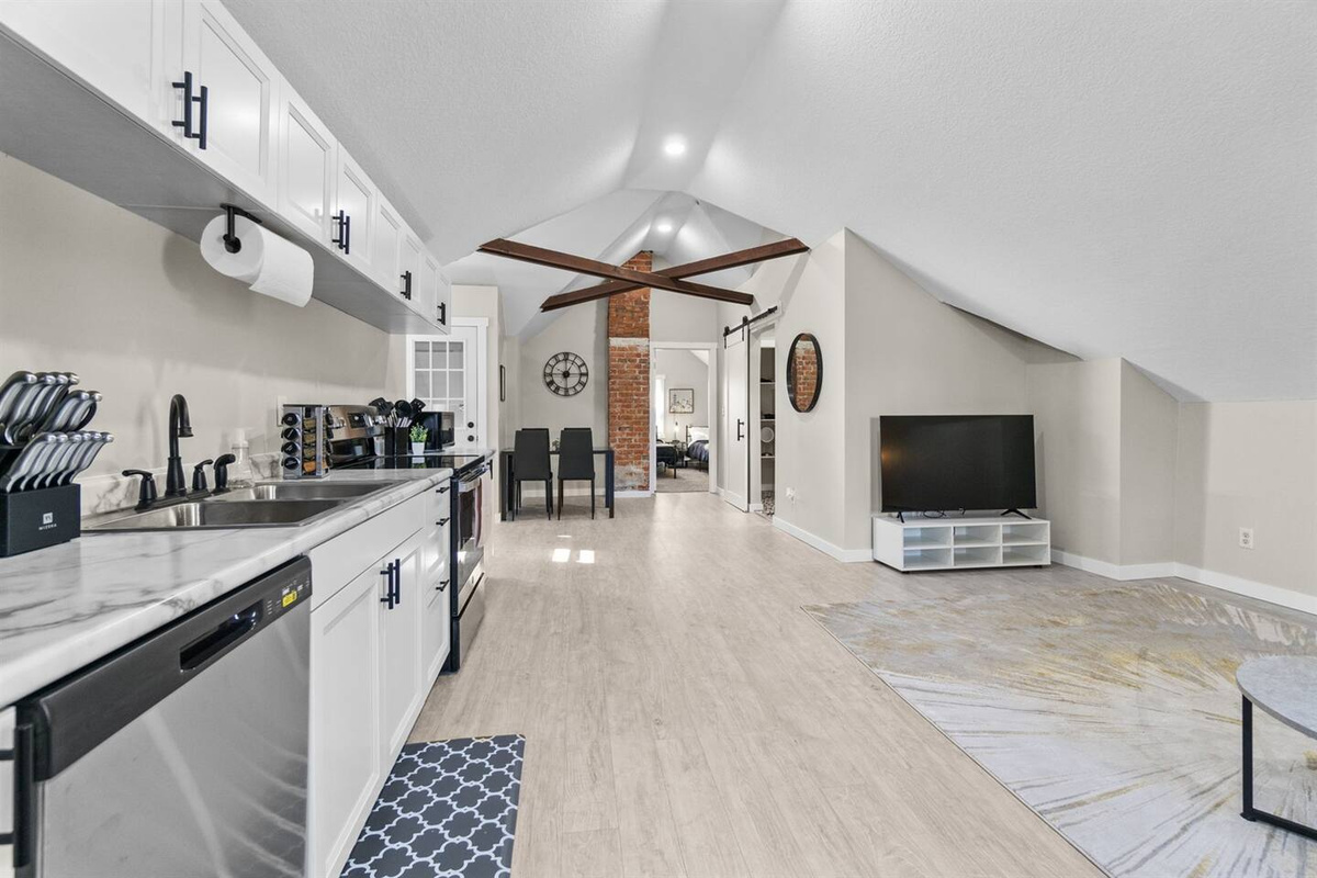 An open-concept space combining the kitchen, living, and dining areas, creating a spacious and seamless flow.
