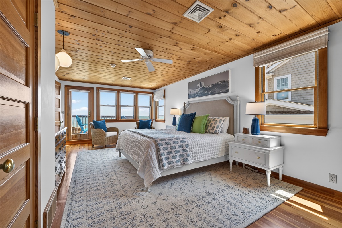 Bright coastal bedroom with stunning ocean views and private deck access, your perfect seaside retreat. 🌊