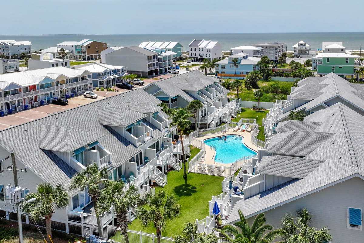 Aerial view of the coastal community featuring a sparkling resort-style pool