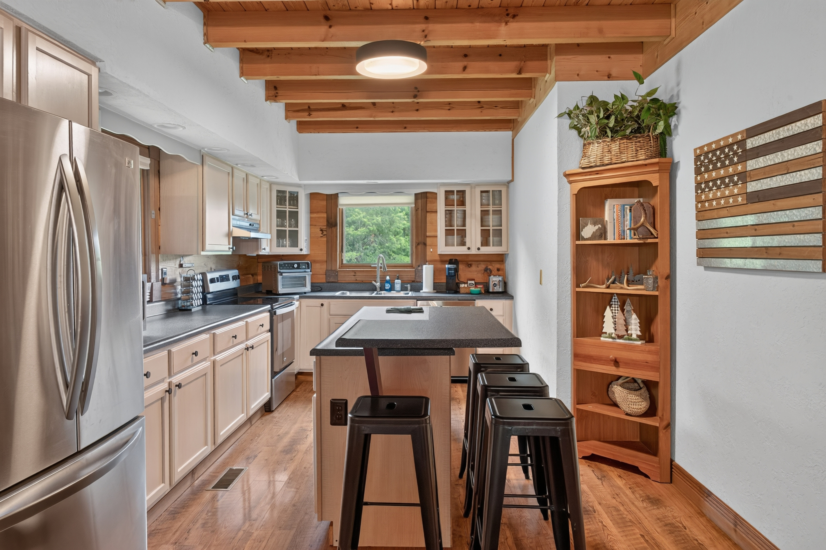 Fully equipped kitchen with seating at the counter. Features include all basics plus air fryer, 2 coffee makers, basic spices, full sized refrigerator and freezer, pancake griddle, waffle maker, kid friendly plates/cups and more.