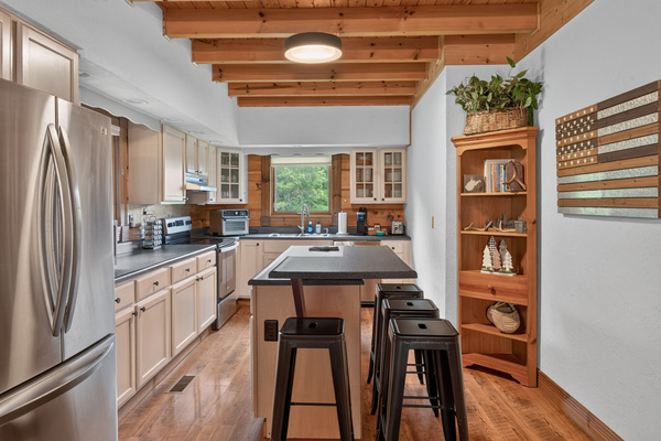 Fully equipped kitchen with seating at the counter. Features include all basics plus air fryer, 2 coffee makers, basic spices, full sized refrigerator and freezer, pancake griddle, waffle maker, kid friendly plates/cups and more.