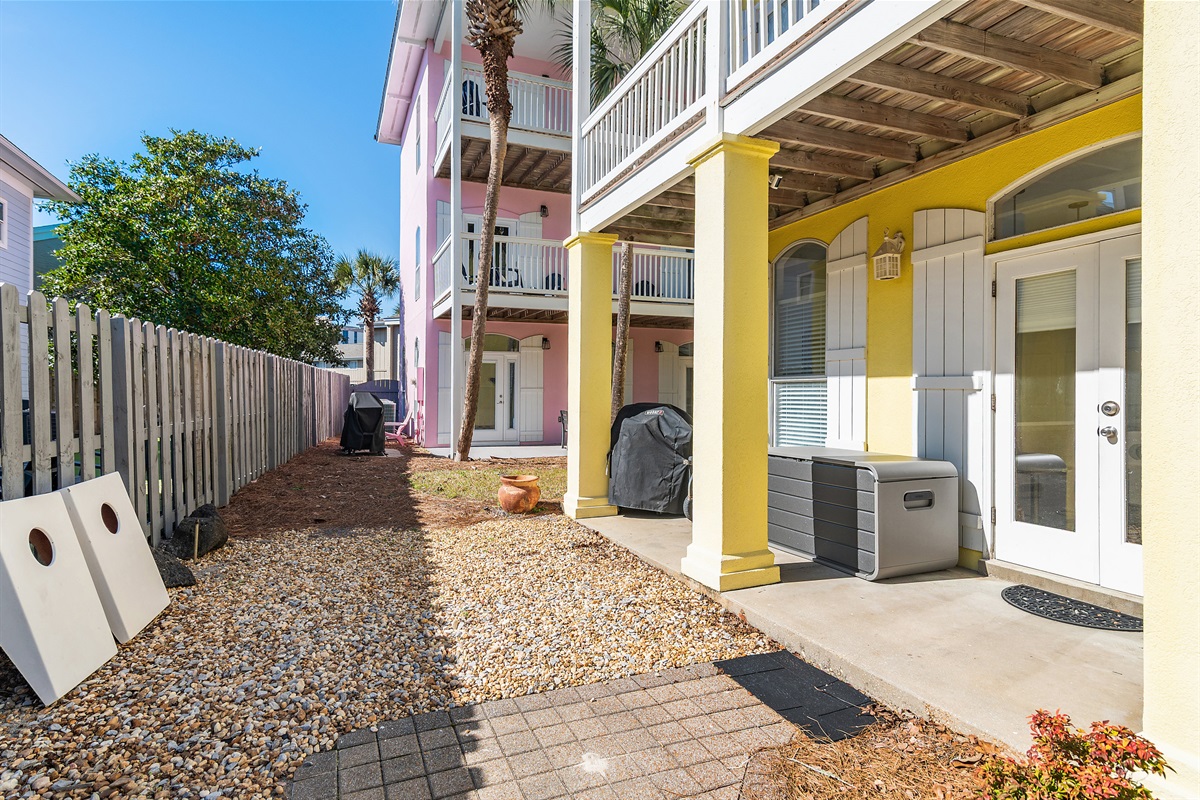 Spacious Backyard with plenty of room for the kids to play, Cornhole set, beach gear storage, and plenty of seating under the covered patio