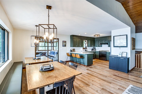 Dining area with seating for large groups and lake-adjacent deck access