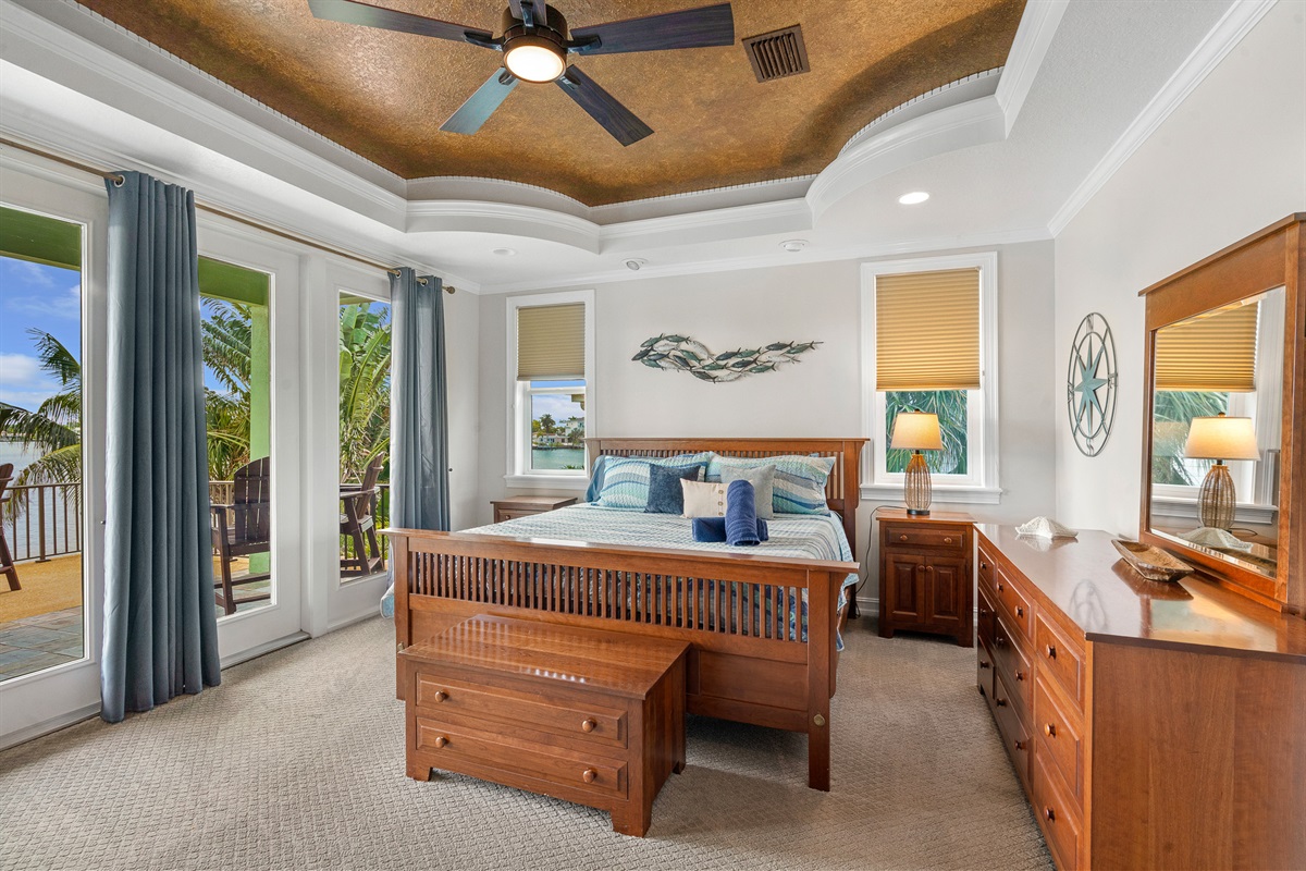 The second floor master bedroom offers stunning water views and private balcony.
