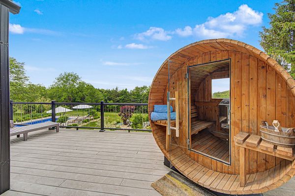 Cedar barrel sauna with the valley in front of you. Heat up, walk ten steps, drop into the pool.
