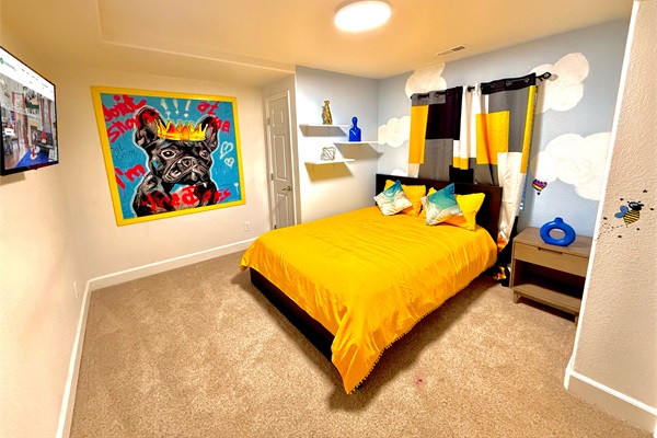 Cozy queen bed in the kid zone downstairs, offering a fun and comfortable space for rest and play