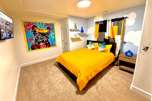 Cozy queen bed in the kid zone downstairs, offering a fun and comfortable space for rest and play