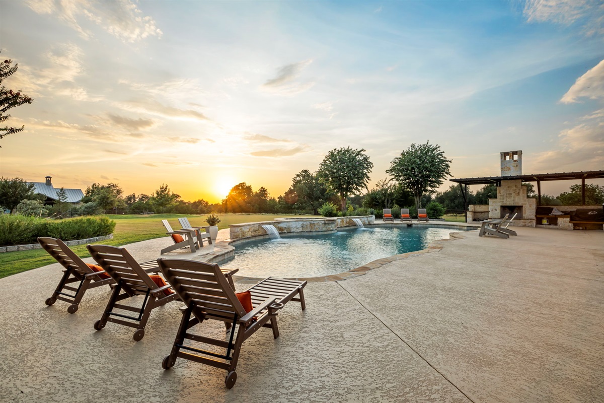 Lounge chairs line the edge of a resort-style pool.