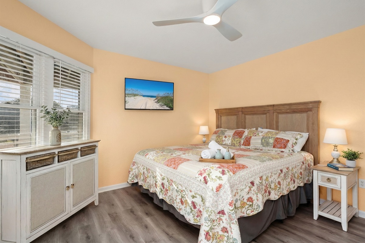 ML Bedroom 4 - Warm and inviting bedroom with a comfortable bed and large windows for natural light.