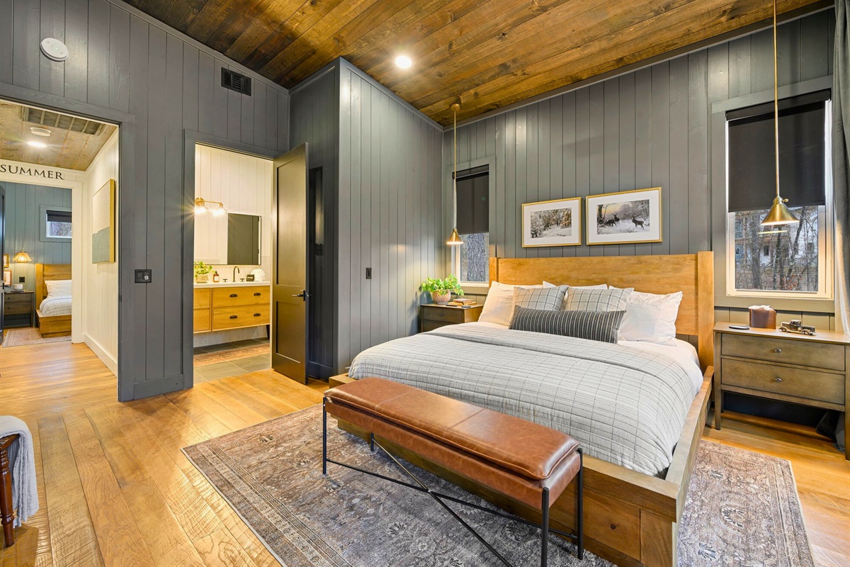 A relaxing seating area and warm wood tones make this sleeping space feel like a private little haven.