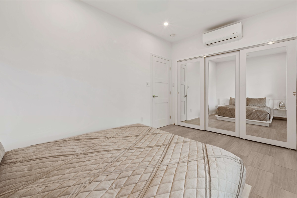 A queen sized bed and large closet in this guest room