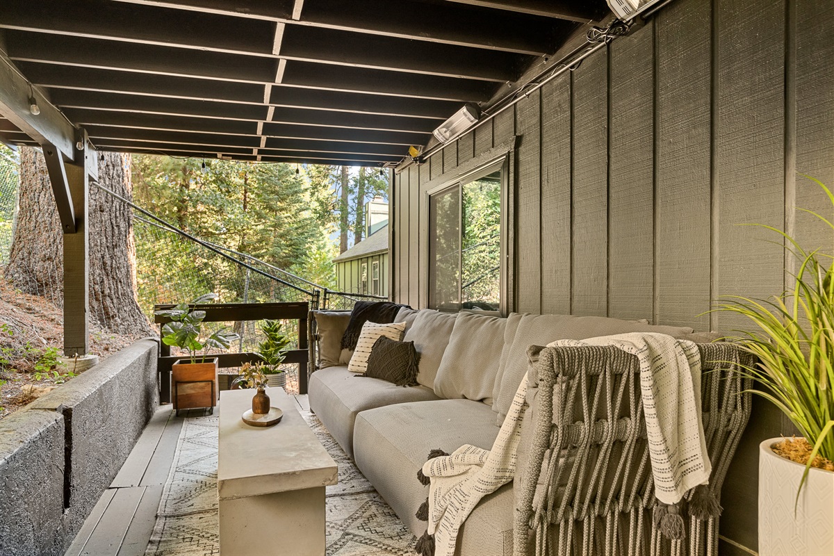 Discover a spacious sofa on the lower deck, complete with overhead space heaters.   It's the perfect setup to enjoy the cool breeze, stay cozy, and catch the stunning Lake Arrowhead sunset or sunrise.