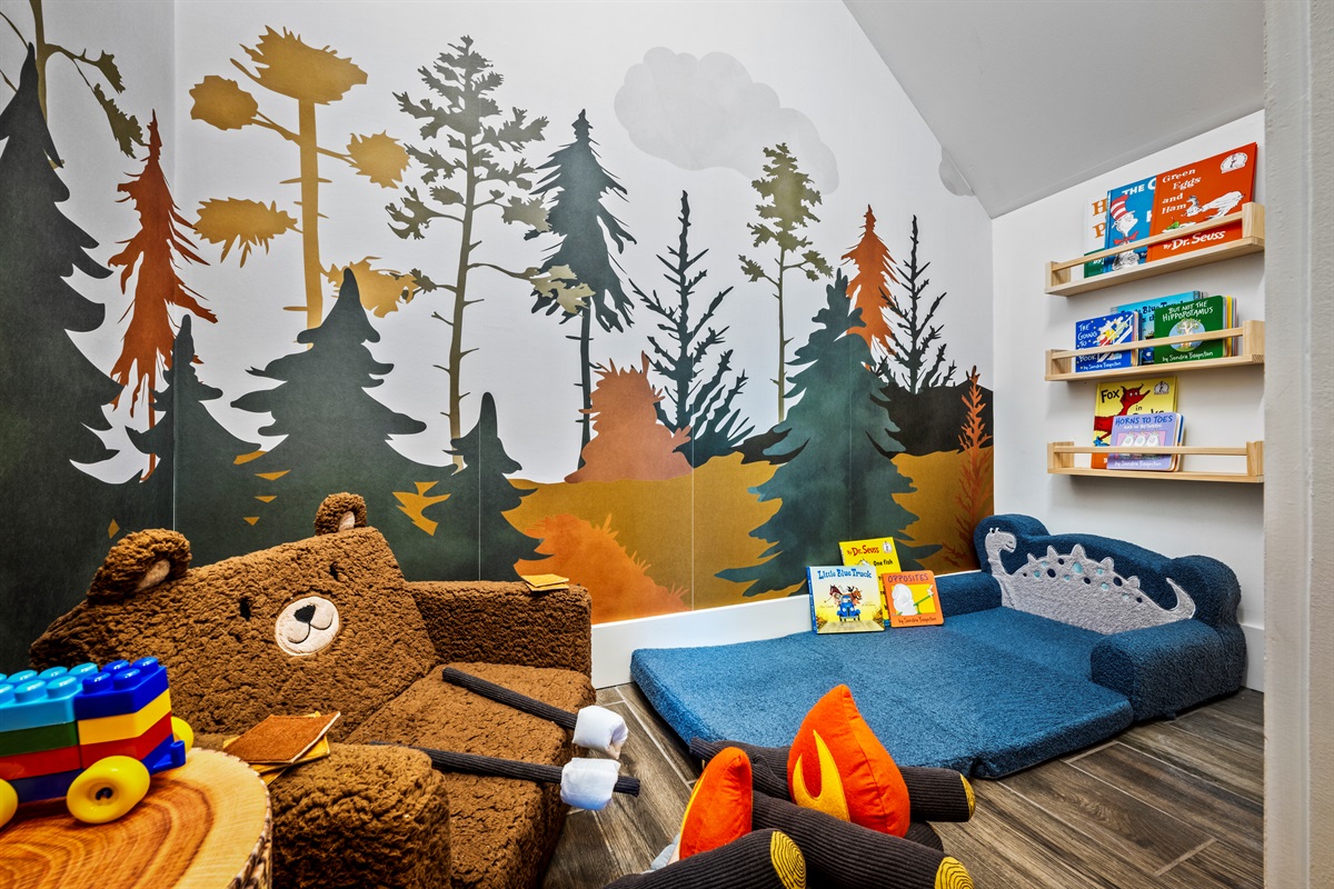 Step into a storybook space just for littles—our woodland-themed toddler nook is stocked with books, plush seating, and Duplo-Legos for safe and imaginative play.