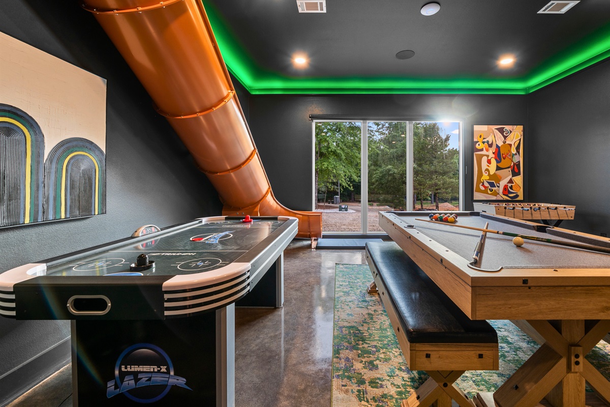 The unique orange slide adds an extra element of excitement, making it a standout feature of this vibrant space.