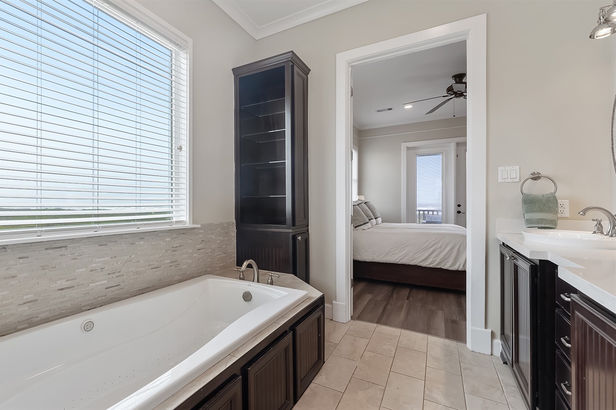 Master Bathroom #1: Large windows throughout provide plenty of light and beach views.