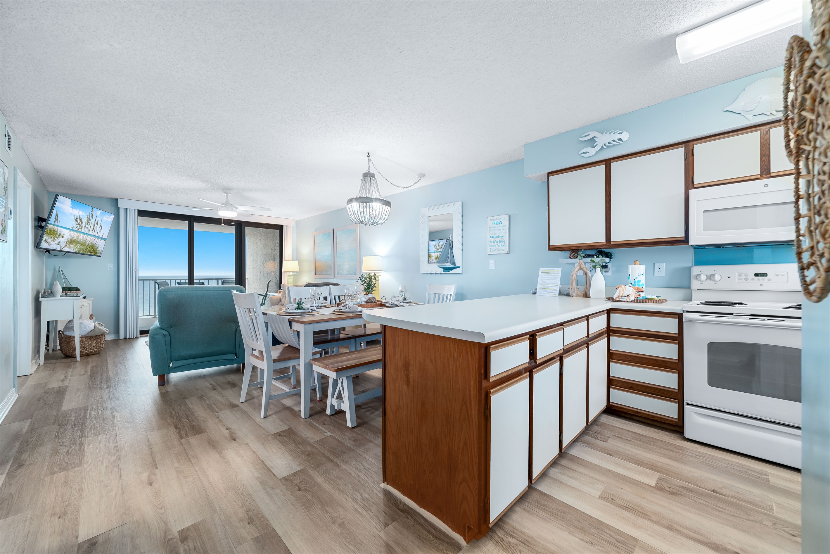 Subtle coastal touches and a neutral palette create a serene and relaxing ambiance in this open living and dining space.