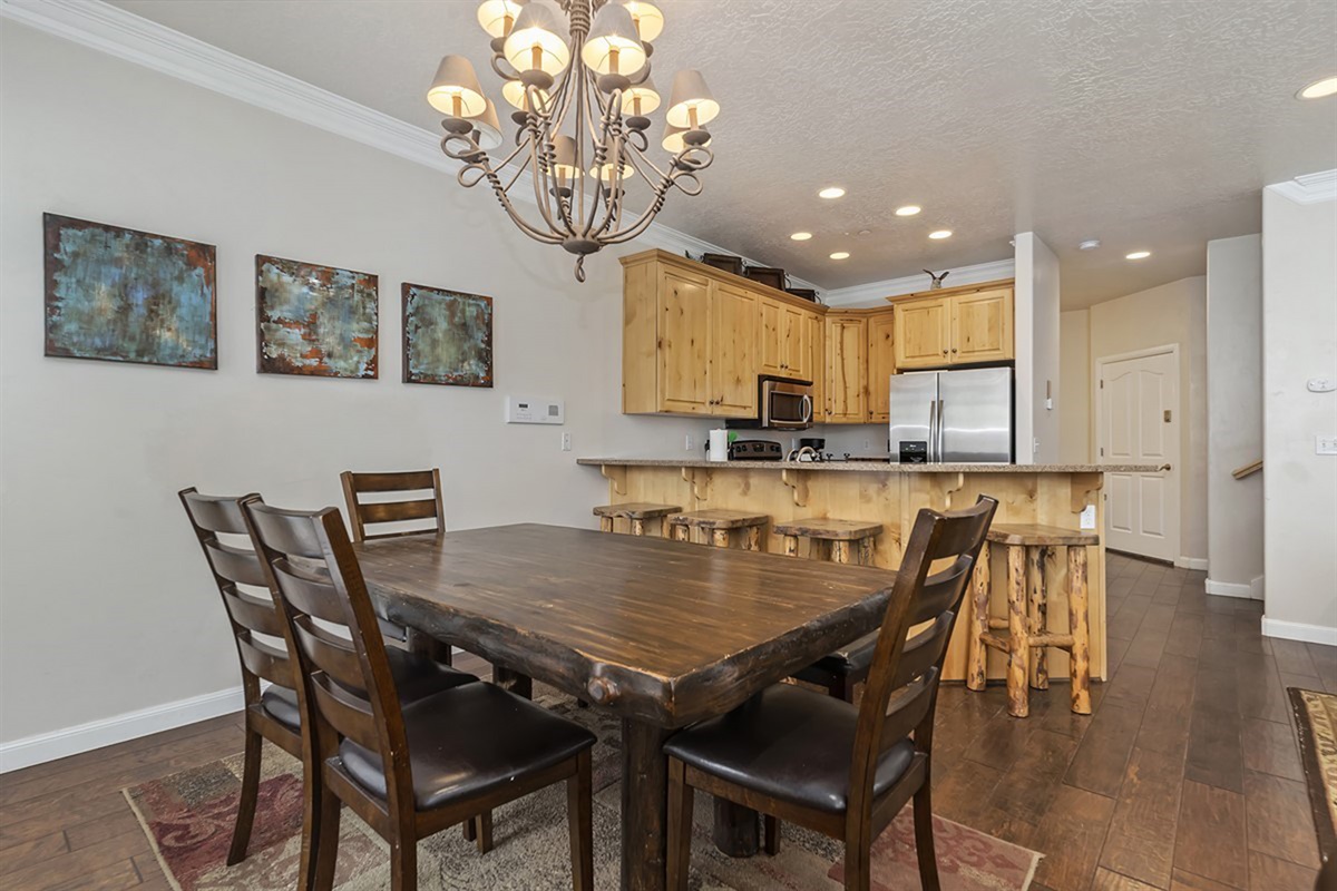 A large dining table paired with warm finishes creates a welcoming space for shared meals and conversation.