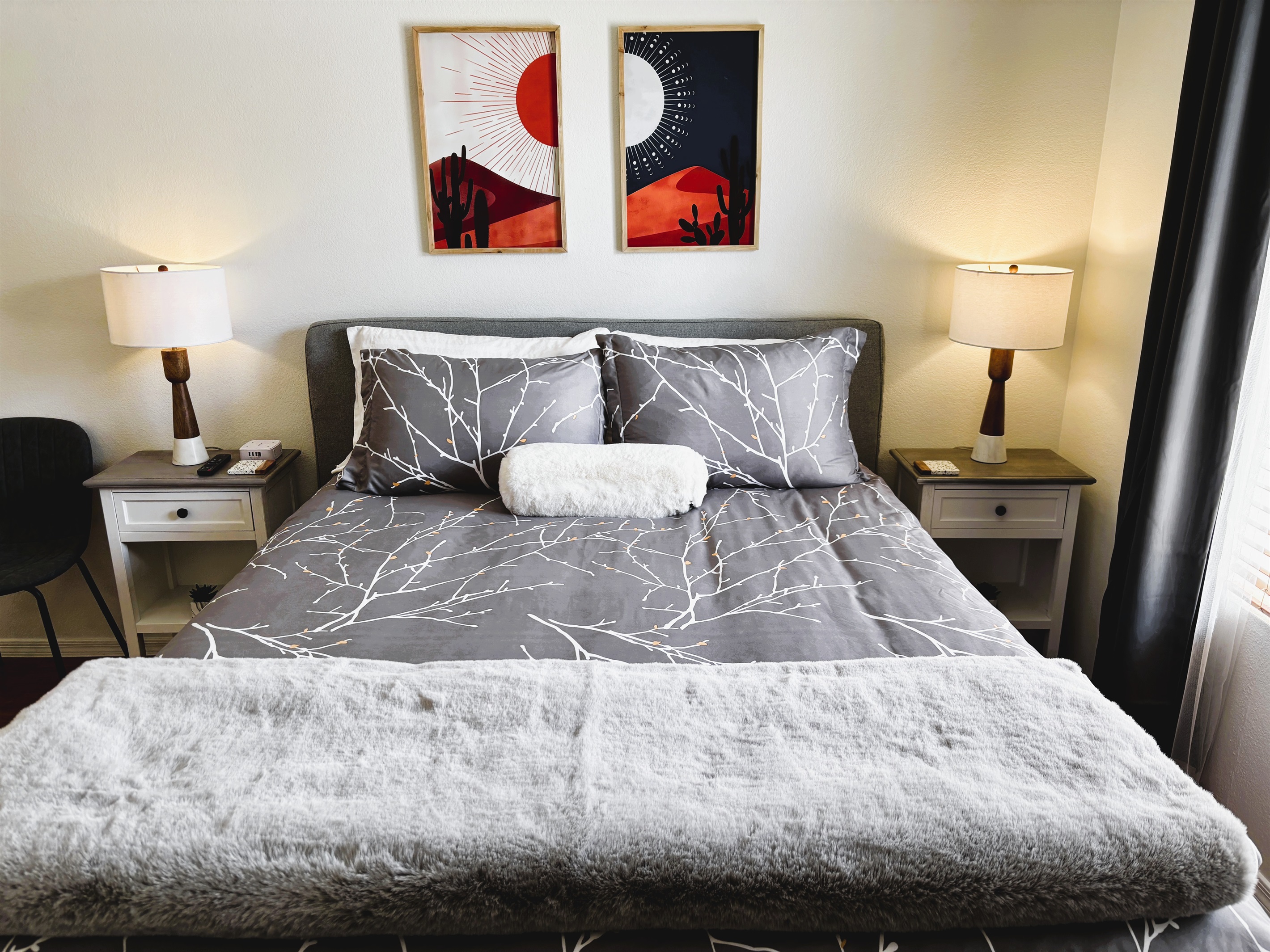 Bedroom with queen bed, smart TV, ceiling fan, blackout curtains and linens